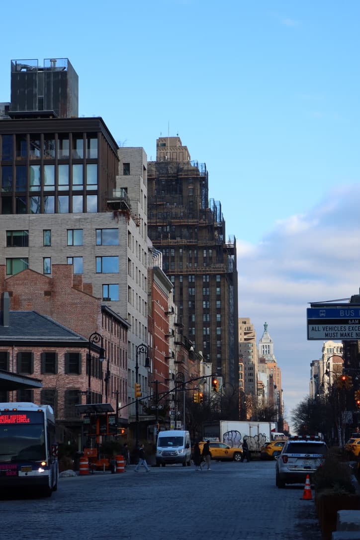 Blue-hour city street scene with buildings and traffic