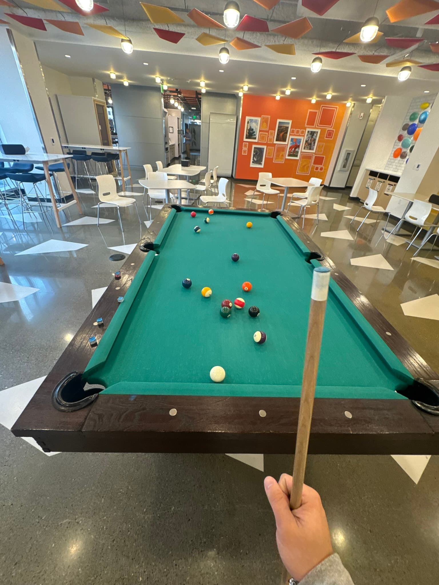 Pool table set up in a bright lounge space
